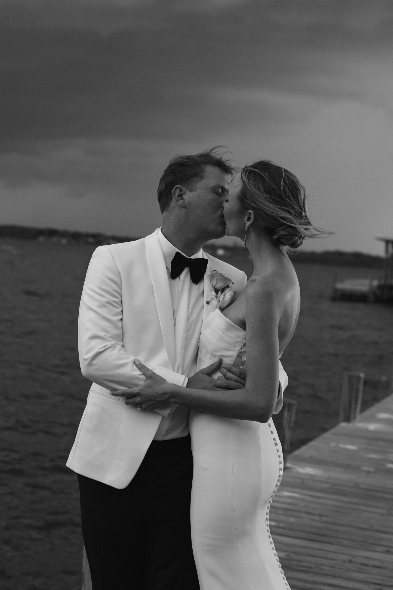     Fort Lauderdale wedding photographer captures a black and white waterfront wedding portrait at sunset.
