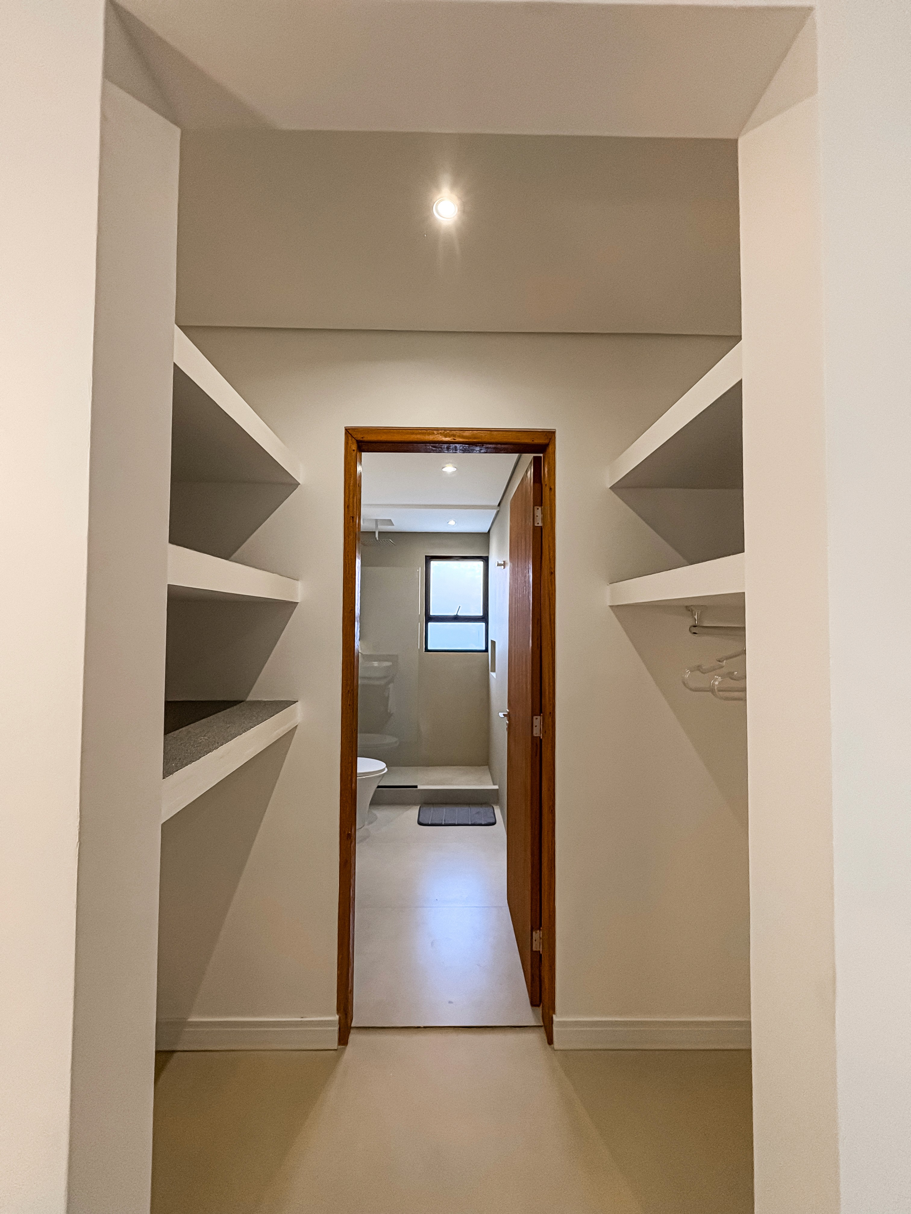 Top-down flat lay of small decor vignette, including coastal magazines on a coffee table, ceramic cups, linen throw on sofa, and part of a jute rug.