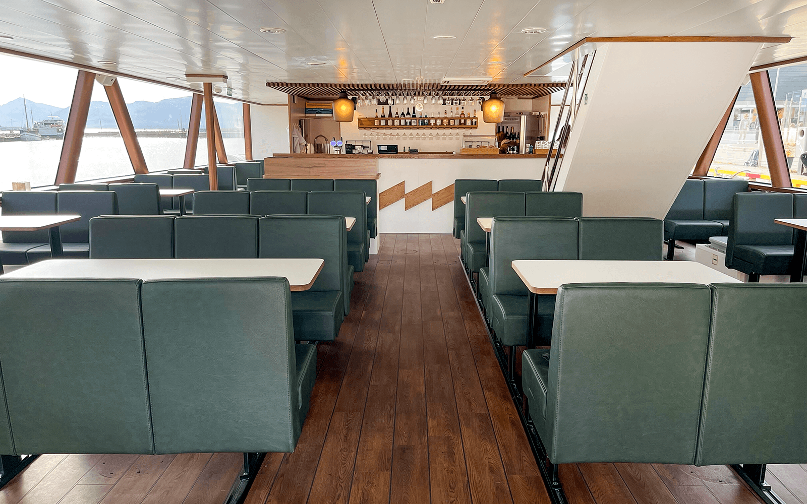 Interior of a boat with seating and bar area for Tromso silent whale watching tour.