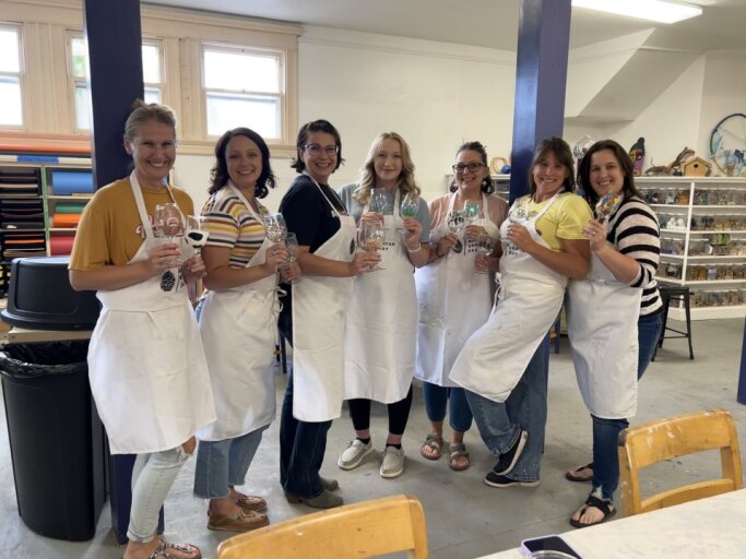 a woman is putting a pair of earplugs on her ear