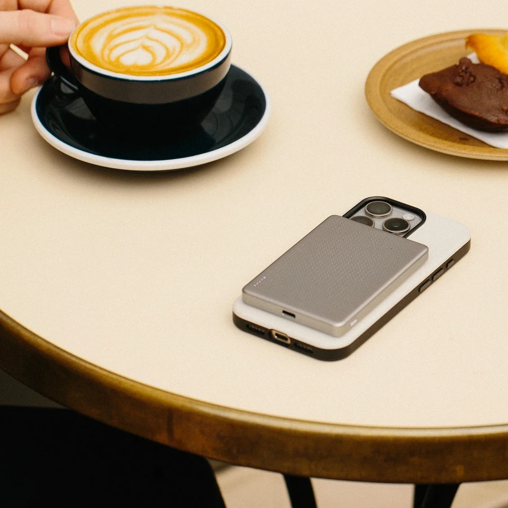 Phone with magnetic power bank laying on table