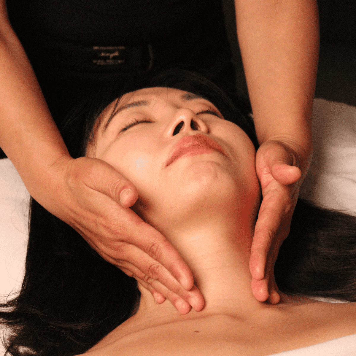 massage practitioner performing lymphatic drainage massage