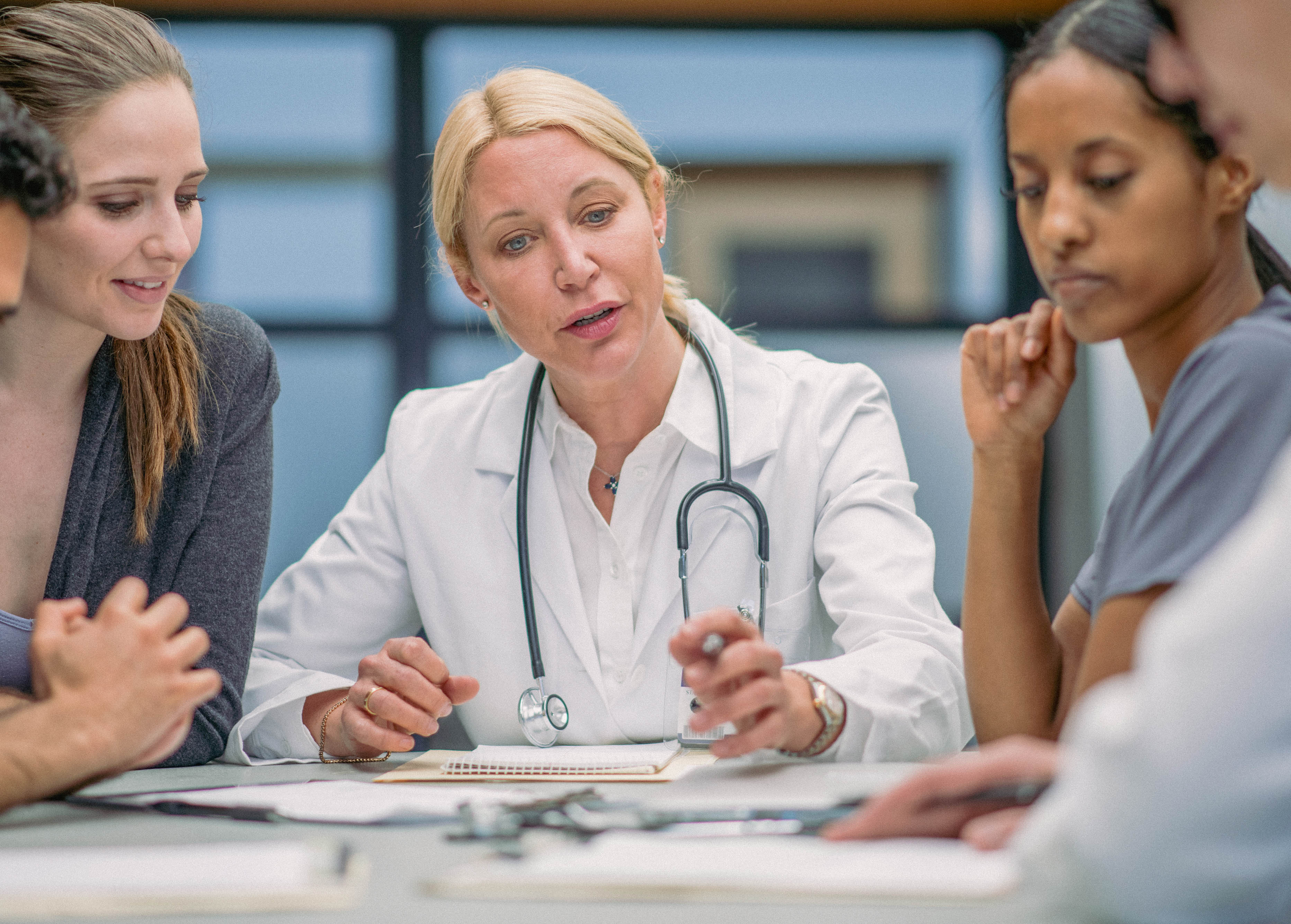 Medical leader in white coat in a meeting