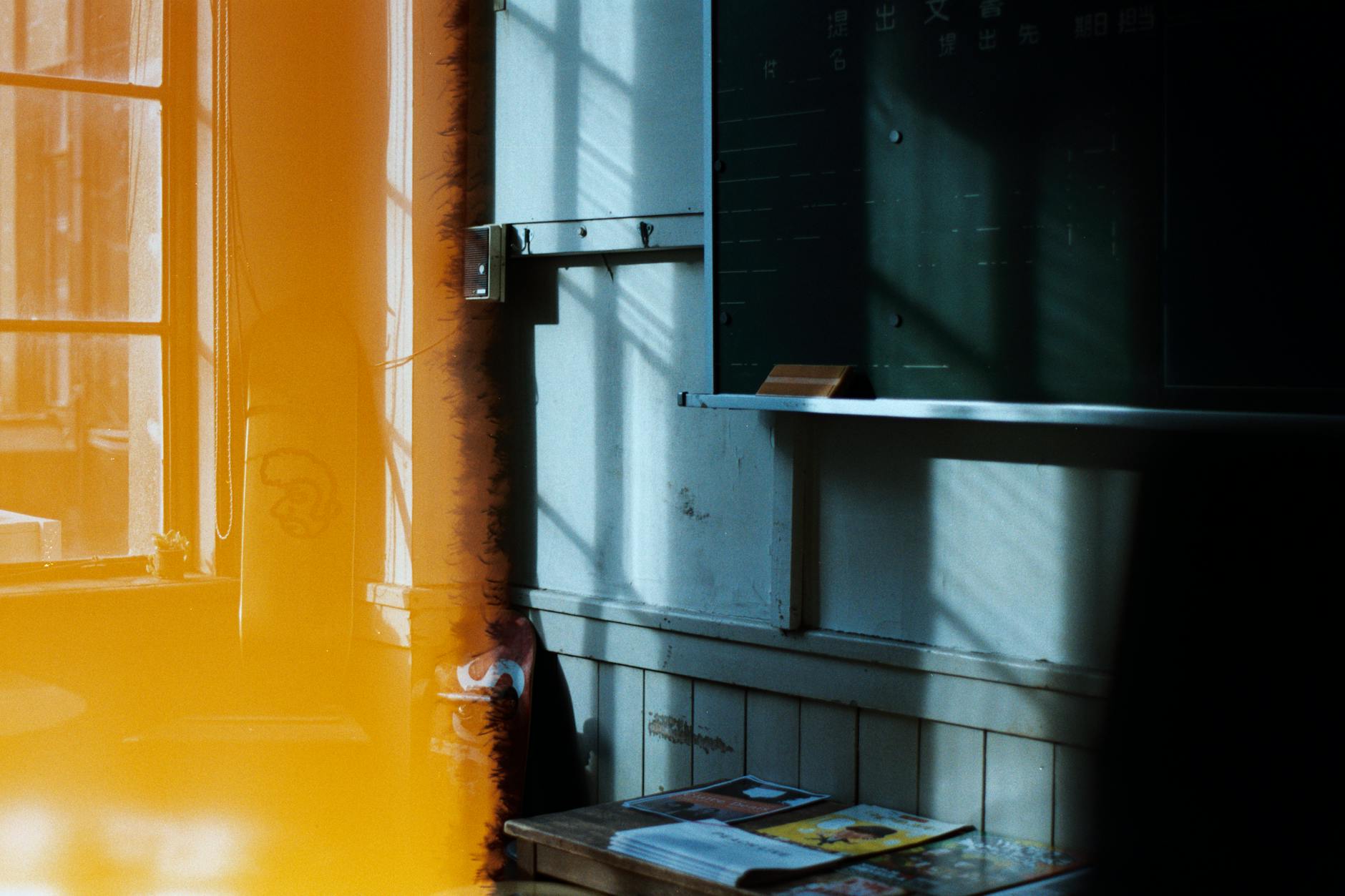 A woman writing in a floral habit tracker journal to establish a consistent routine of self care for educators.