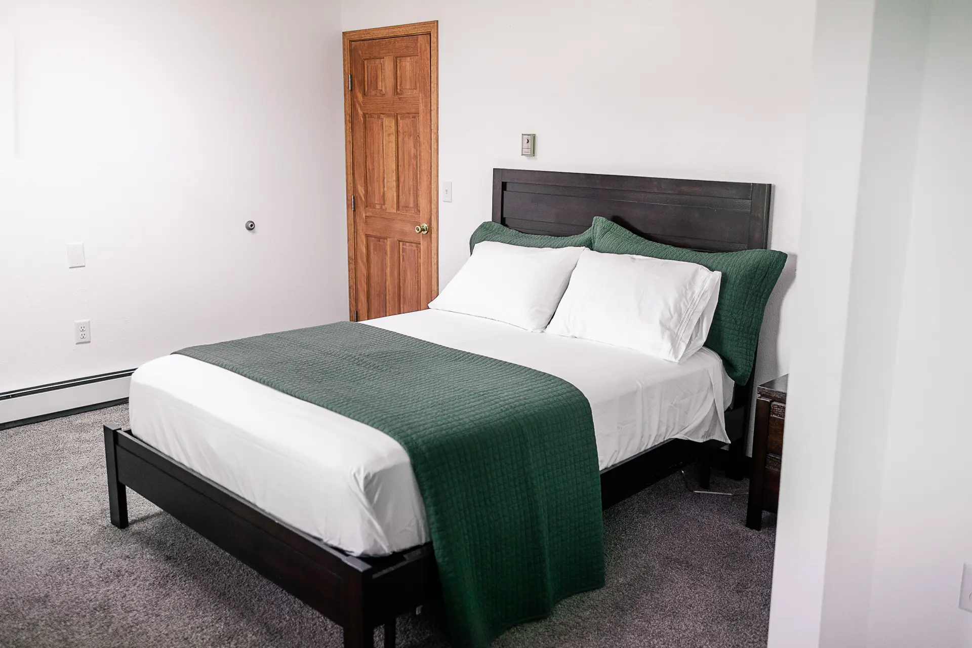 Cozy double room at Trophy Lodge with warm wood finishes.
