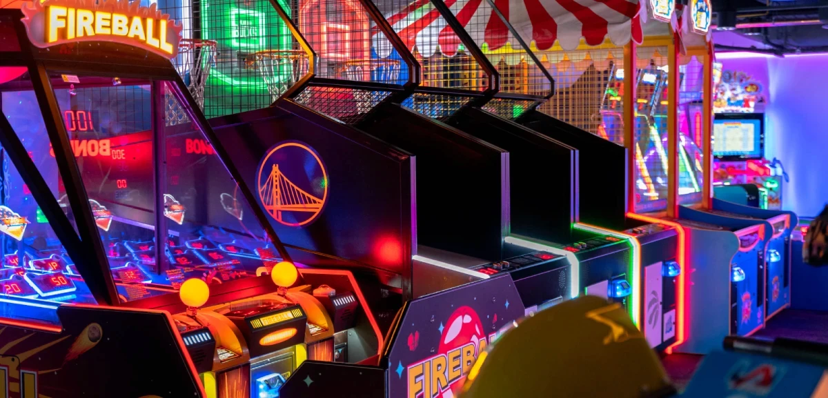 A row of neon lit ticket redemption arcade machines