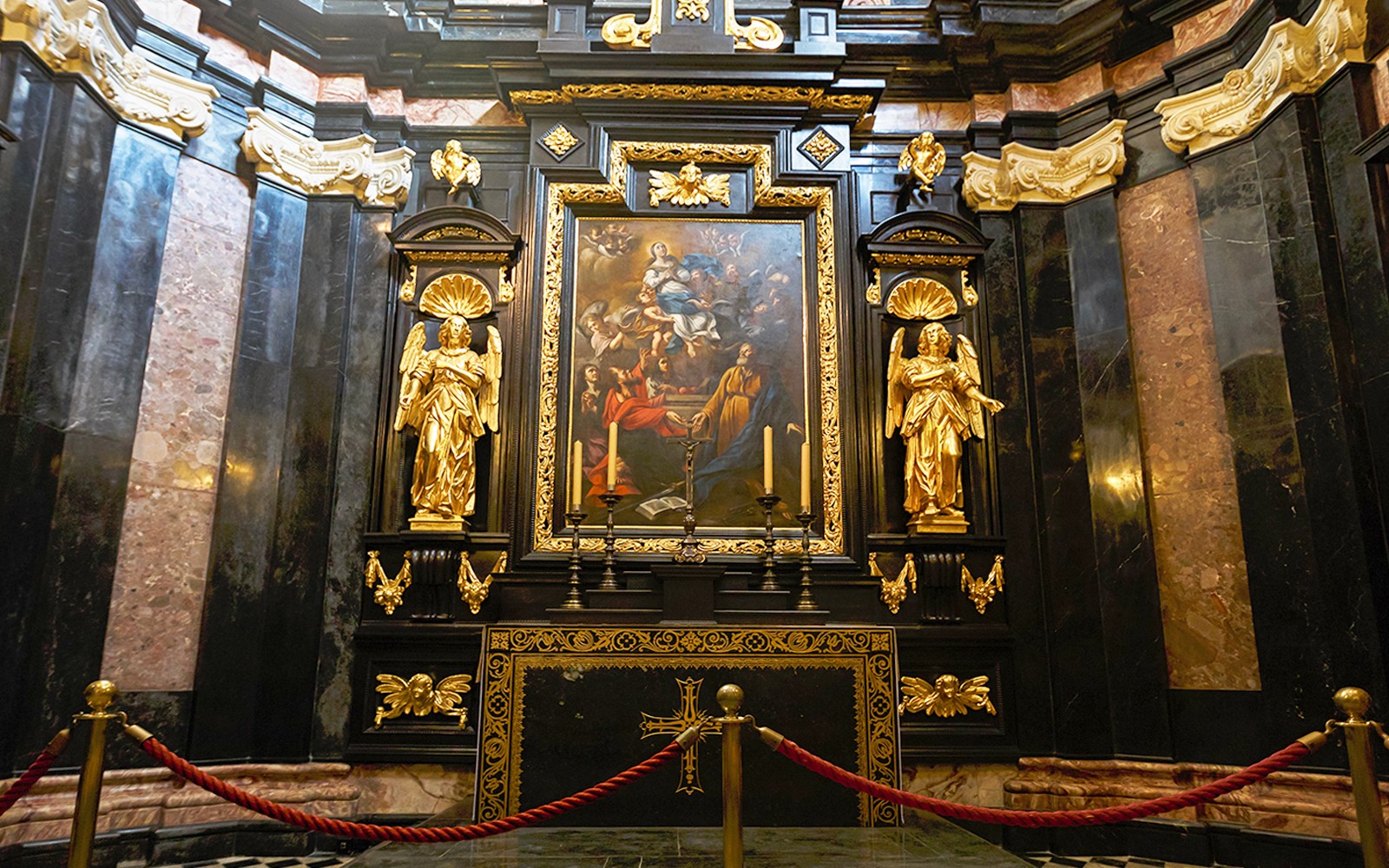 Wawel Cathedral interior with ornate altar and religious artwork.