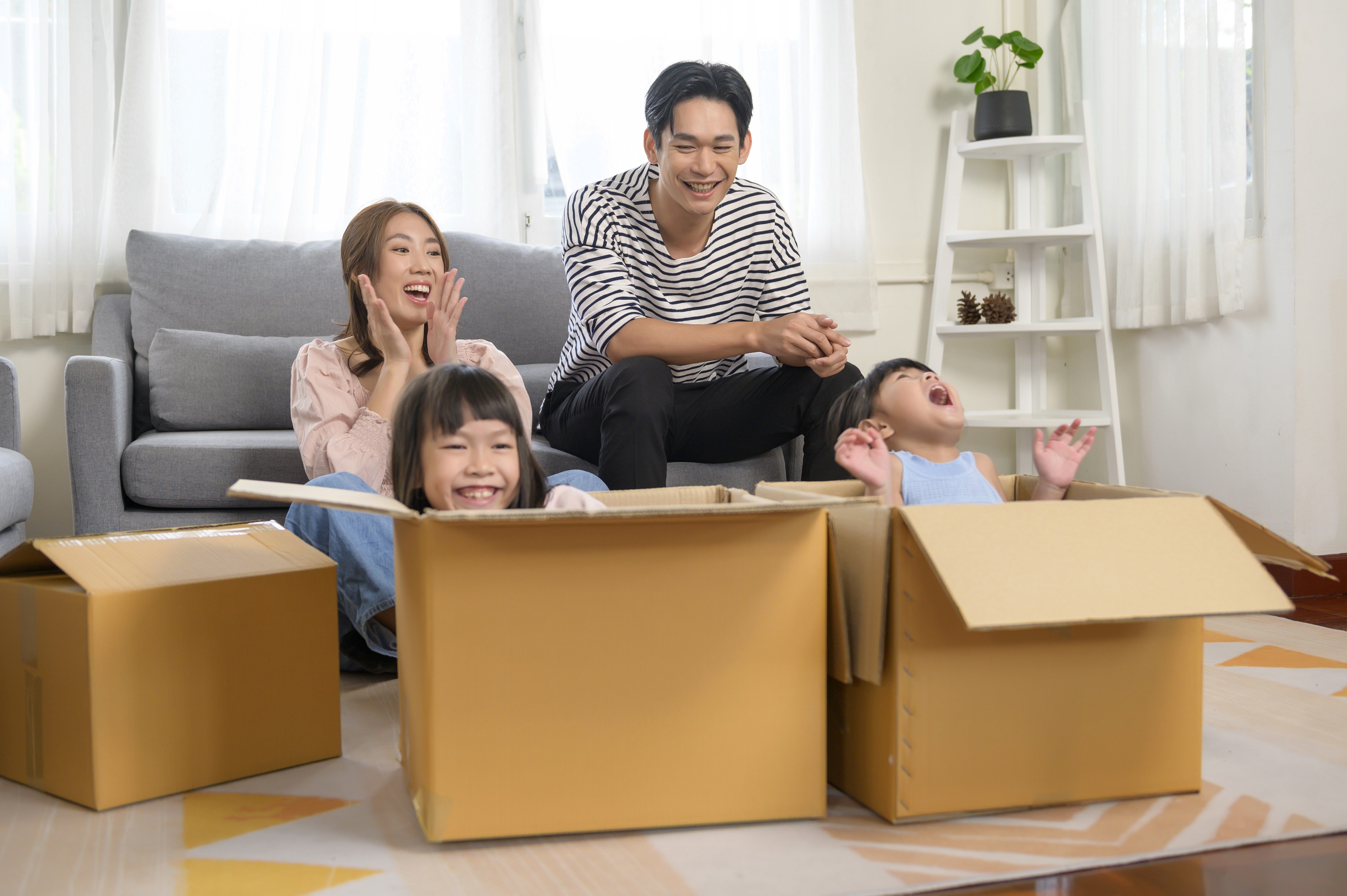 Happy couple relaxing on a couch, representing satisfied homeowners or renters finding their ideal living space in Cambodia.