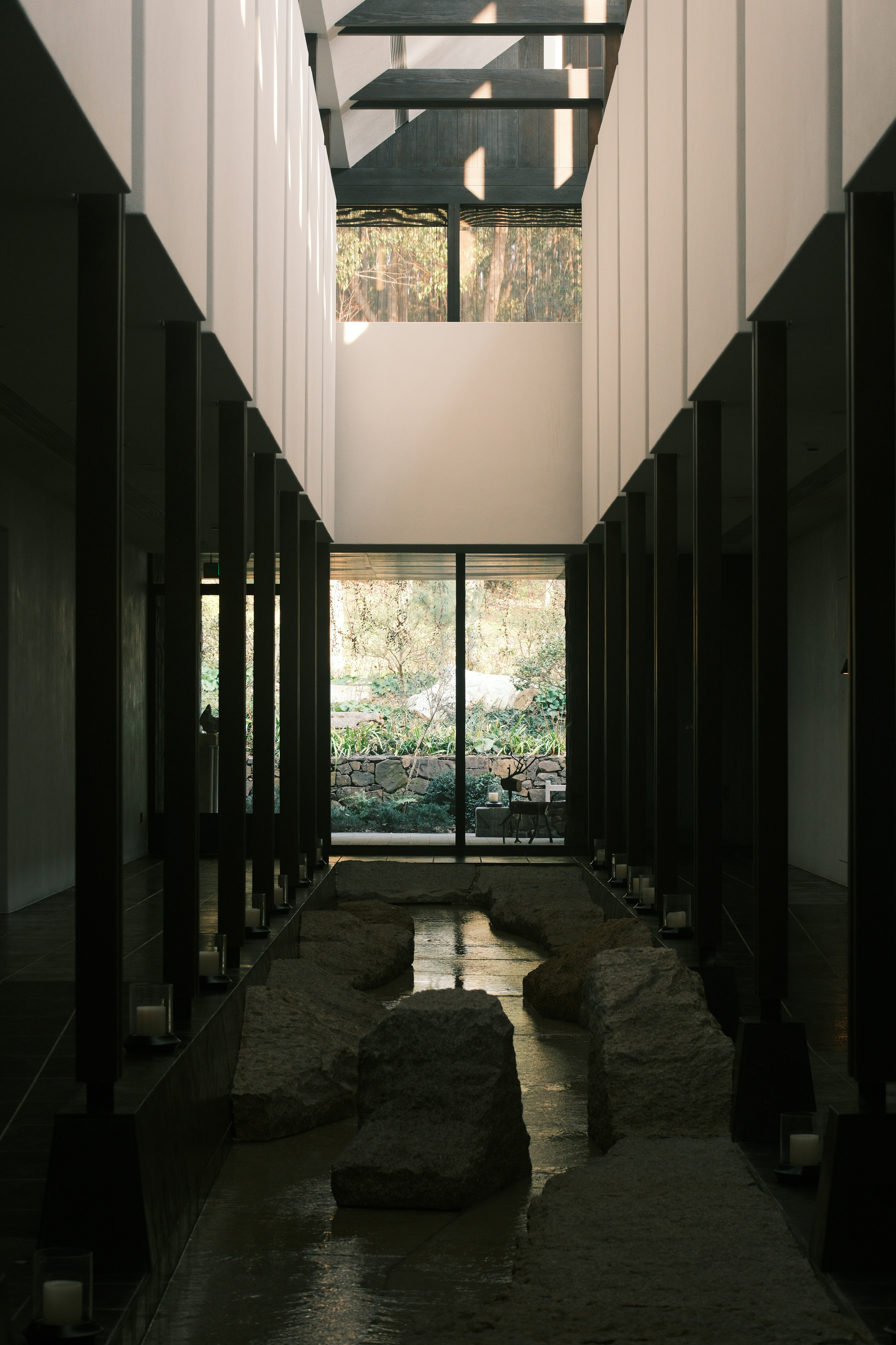 Modern hallway with water feature and large windows
