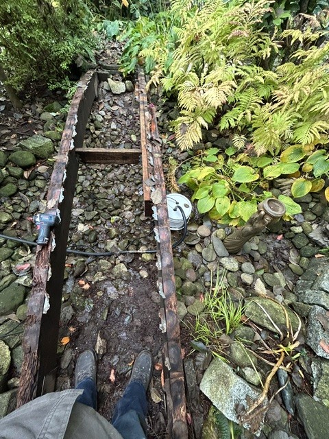 Deteriorated wood garden footbridge before removal and reconstruction.