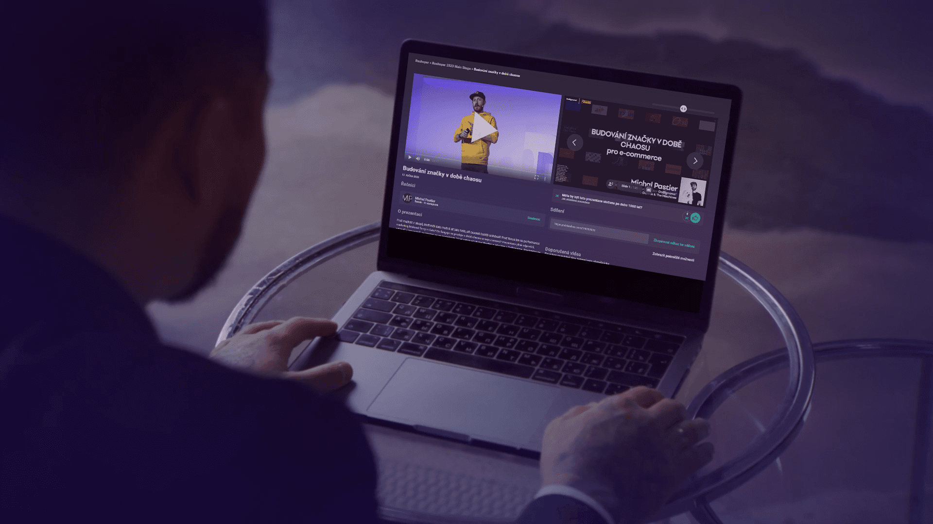 Person viewing a lecture on SlidesLive using a laptop.