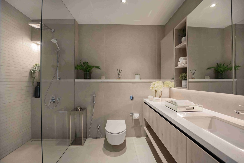 A modern bathroom featuring a sleek glass shower door, designed with luxury in mind, located in Liv Lux, Dubai.