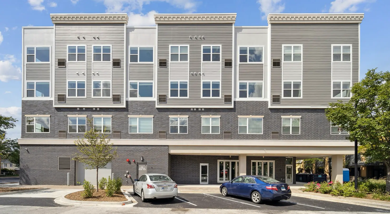 A welcoming front-facing view of The Hartford Apartments in Homewood, Illinois, showcasing the modern apartment complex design.
