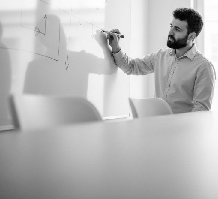 Black and white portrait of a smiling person with curly hair