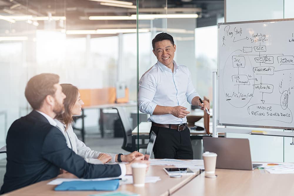 A businessman presents key information to his colleagues