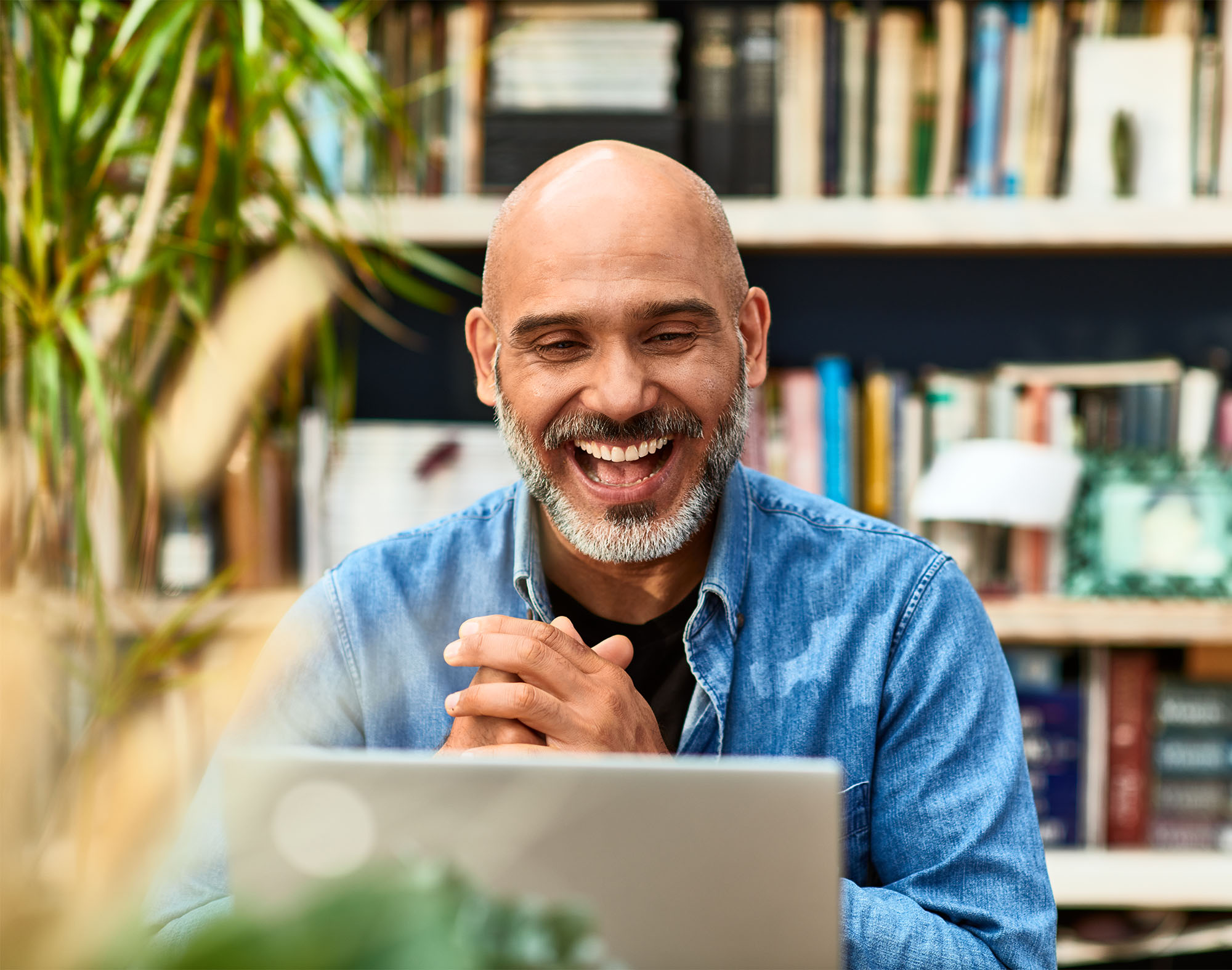 Happy man looking at computer.