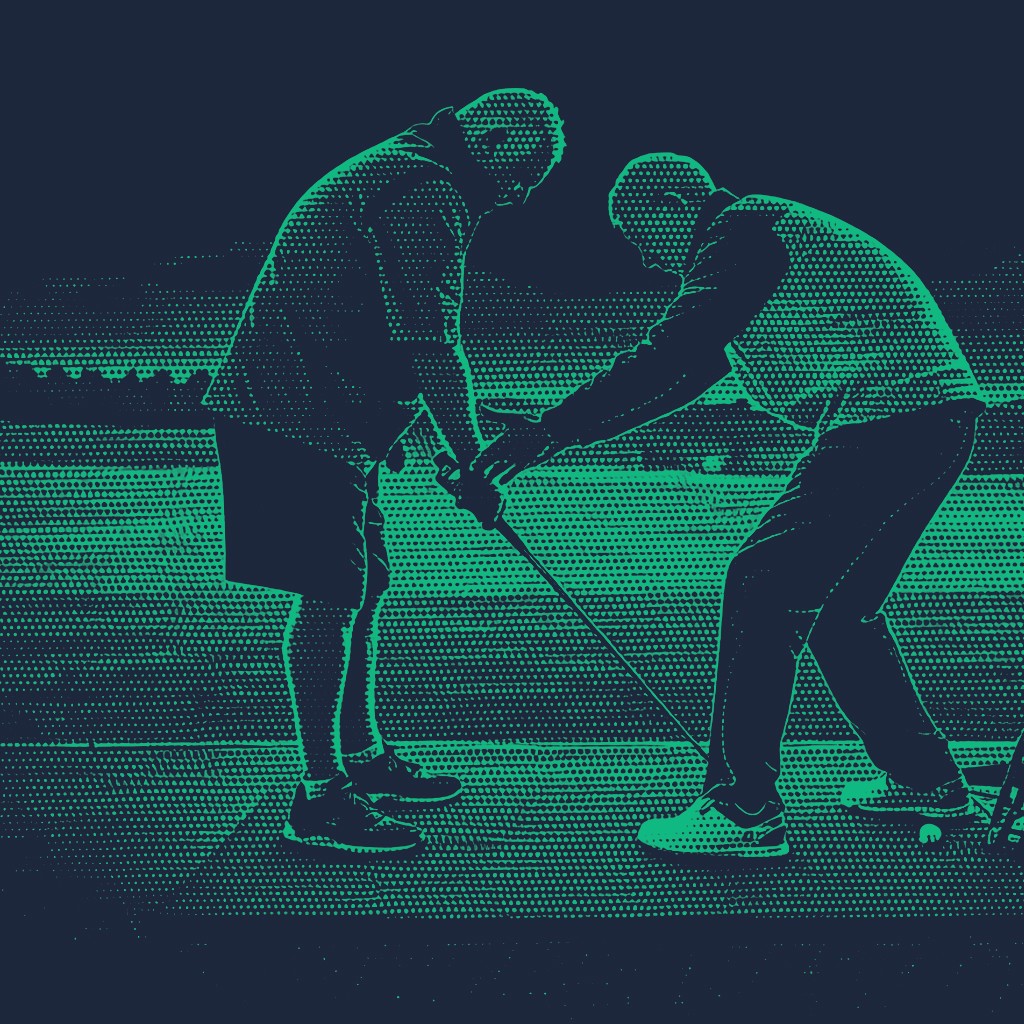 A teal-toned photograph of a golf instructor standing behind a student, physically guiding their grip and stance on a practice range.
