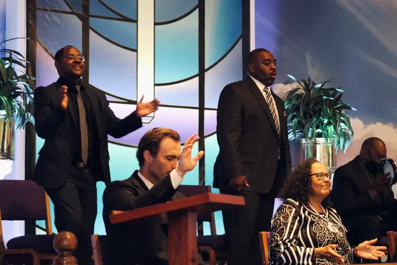 Church leadership and ministers leading worship at Peace Apostolic Church