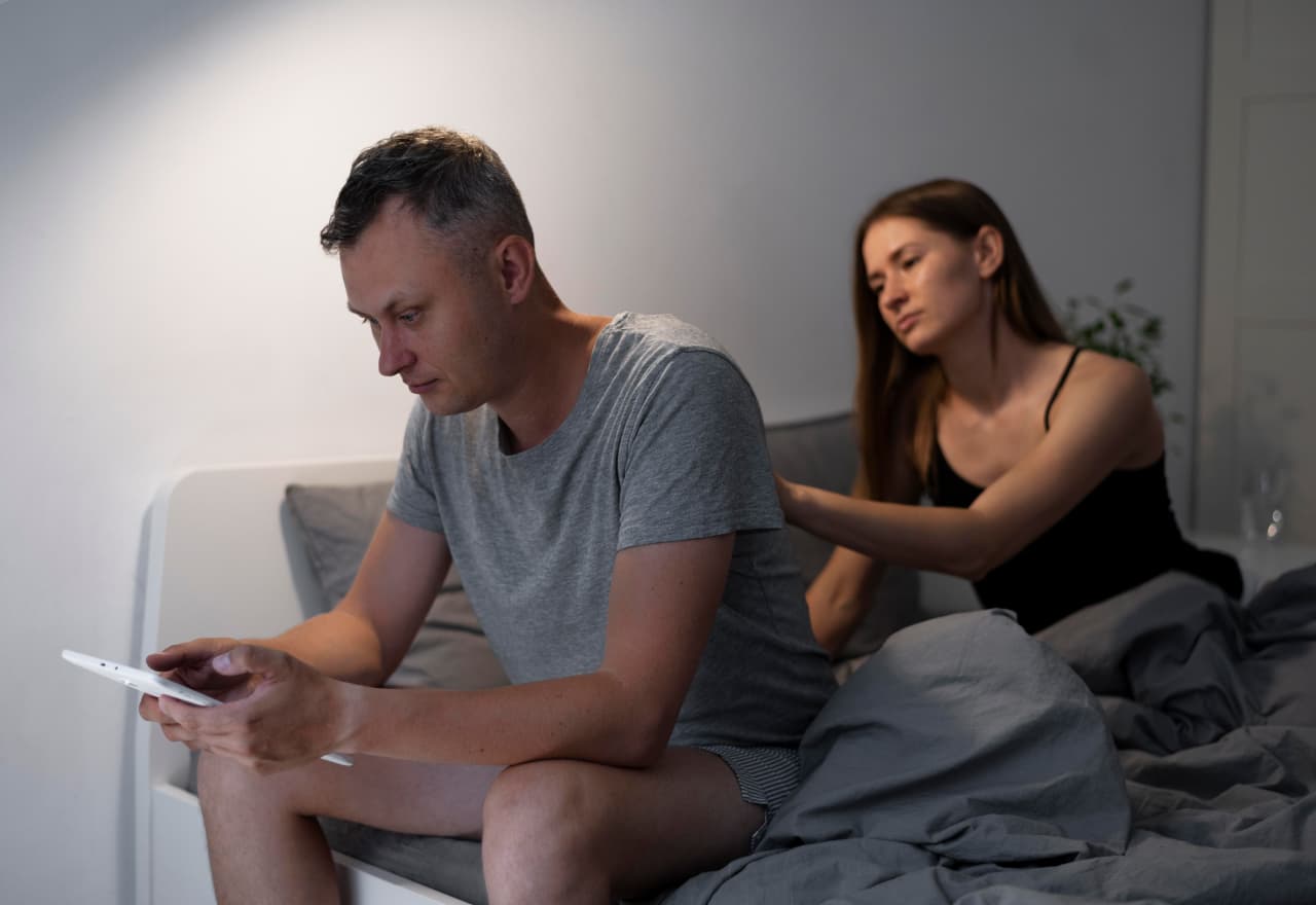 man in bed using phone - Porn Addiction Treatment Encouragement