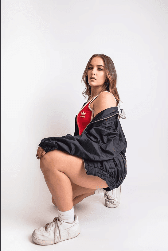 high school senior portrait in sports clothing,