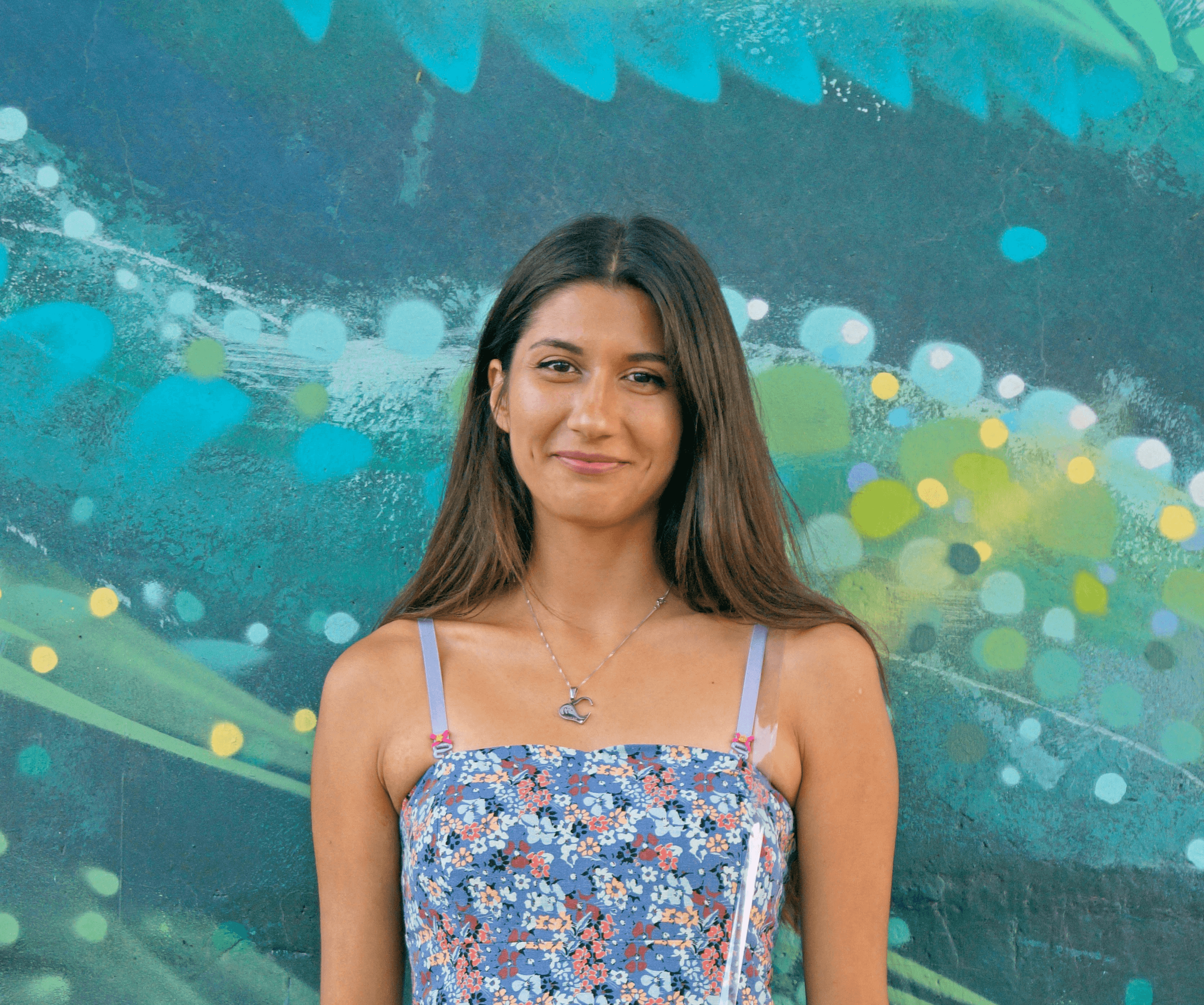 woman wearing blue and white floral spaghetti-strap dress