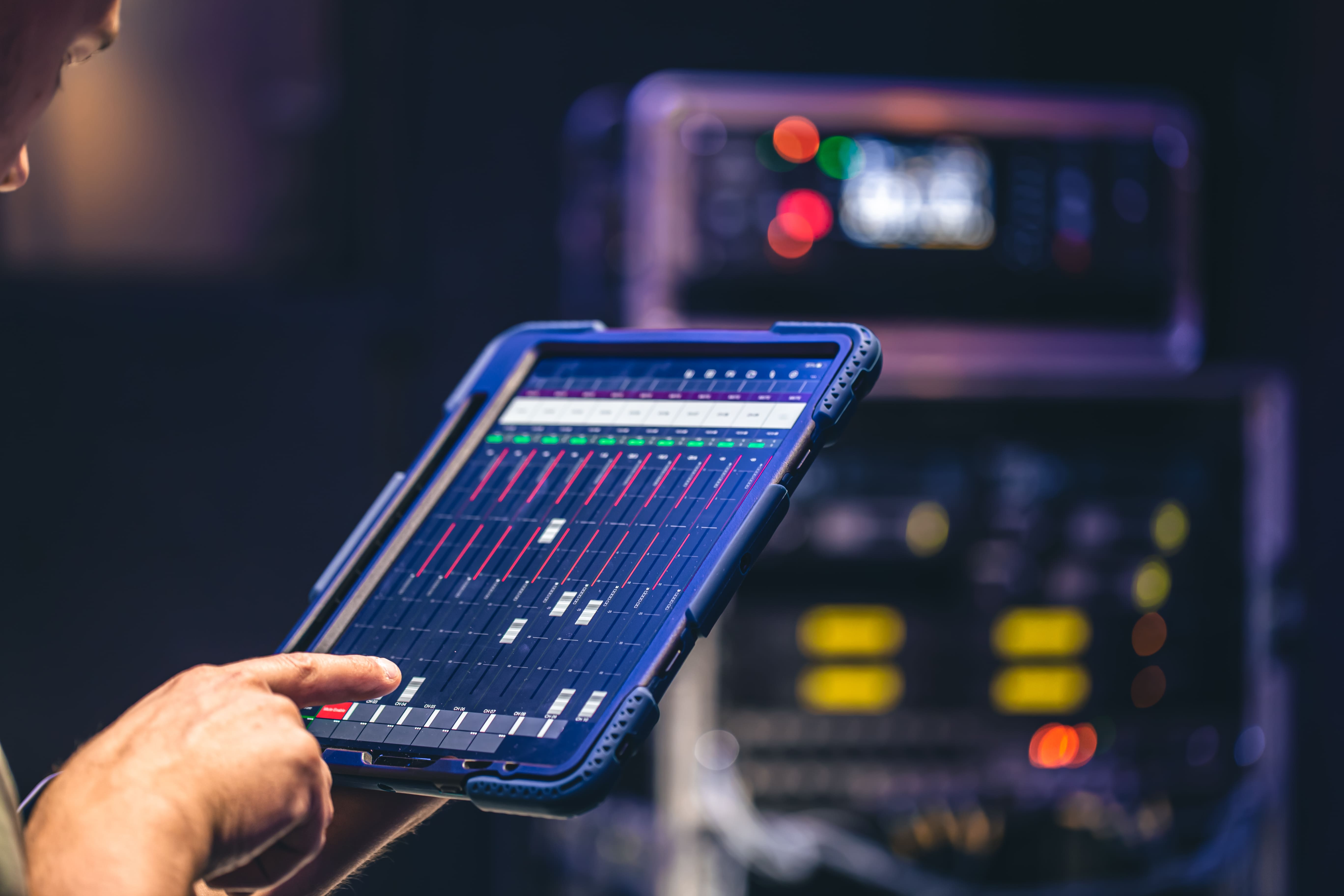 Close-up of a dark green leaf showing its textured surface and central vein against a muted background.