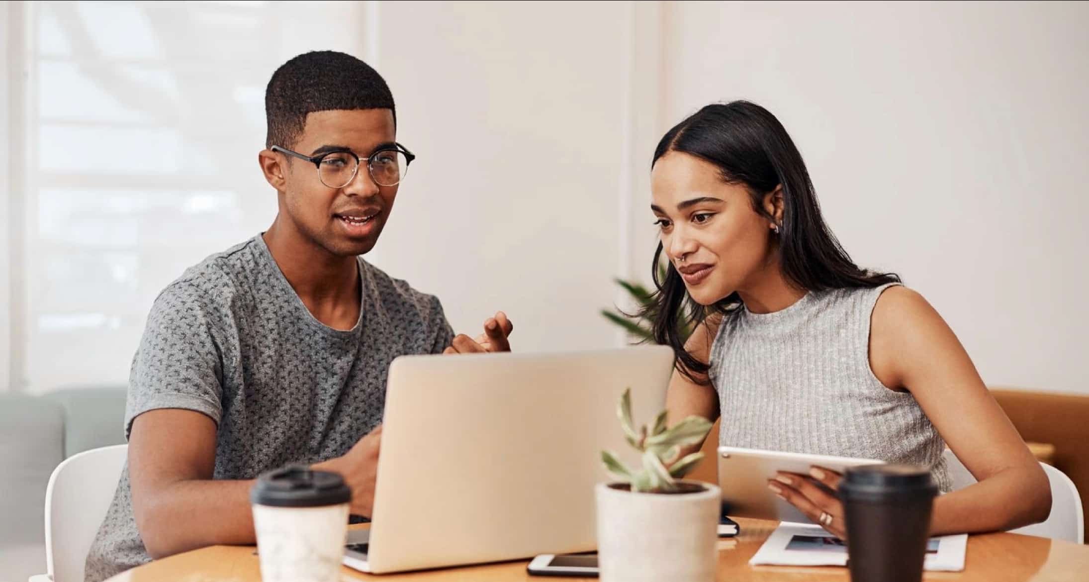 Image of two people staring at computer