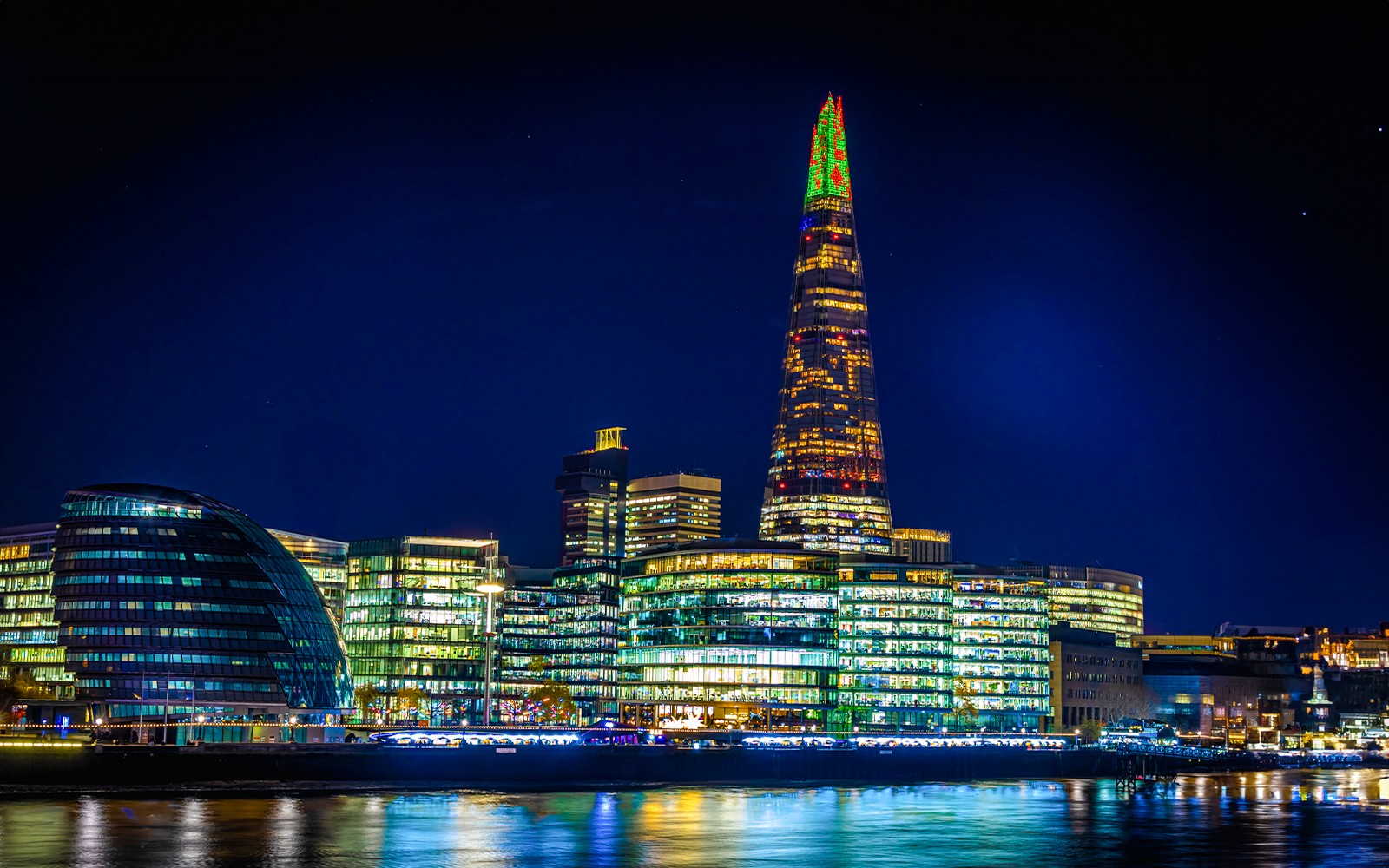 Christmas lights illuminate The Shard in London at night.