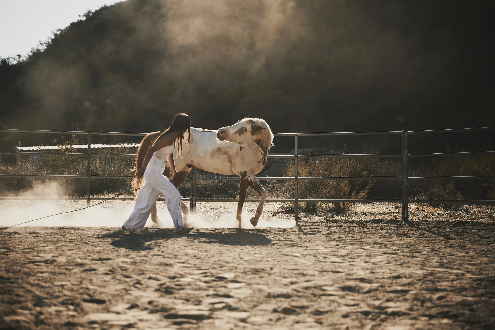 woman leading horse through dust — Alex Saidac photography by Tom Kubik