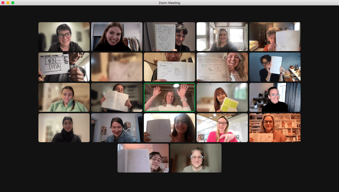 Zoom meeting with women holding up their notebooks