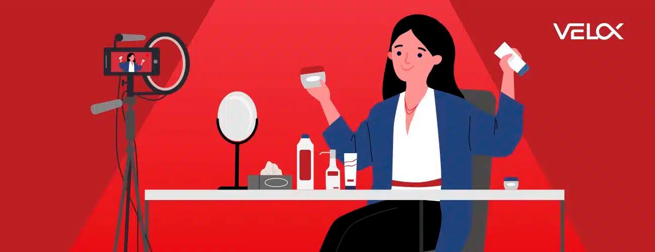A woman sitting at a desk filming herself making skincare products