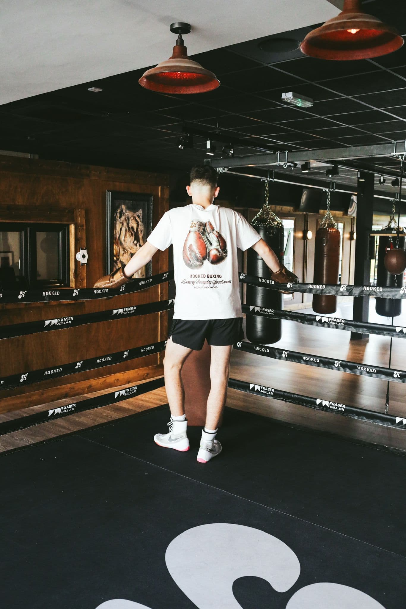 Person working at a desk with a laptop and books.