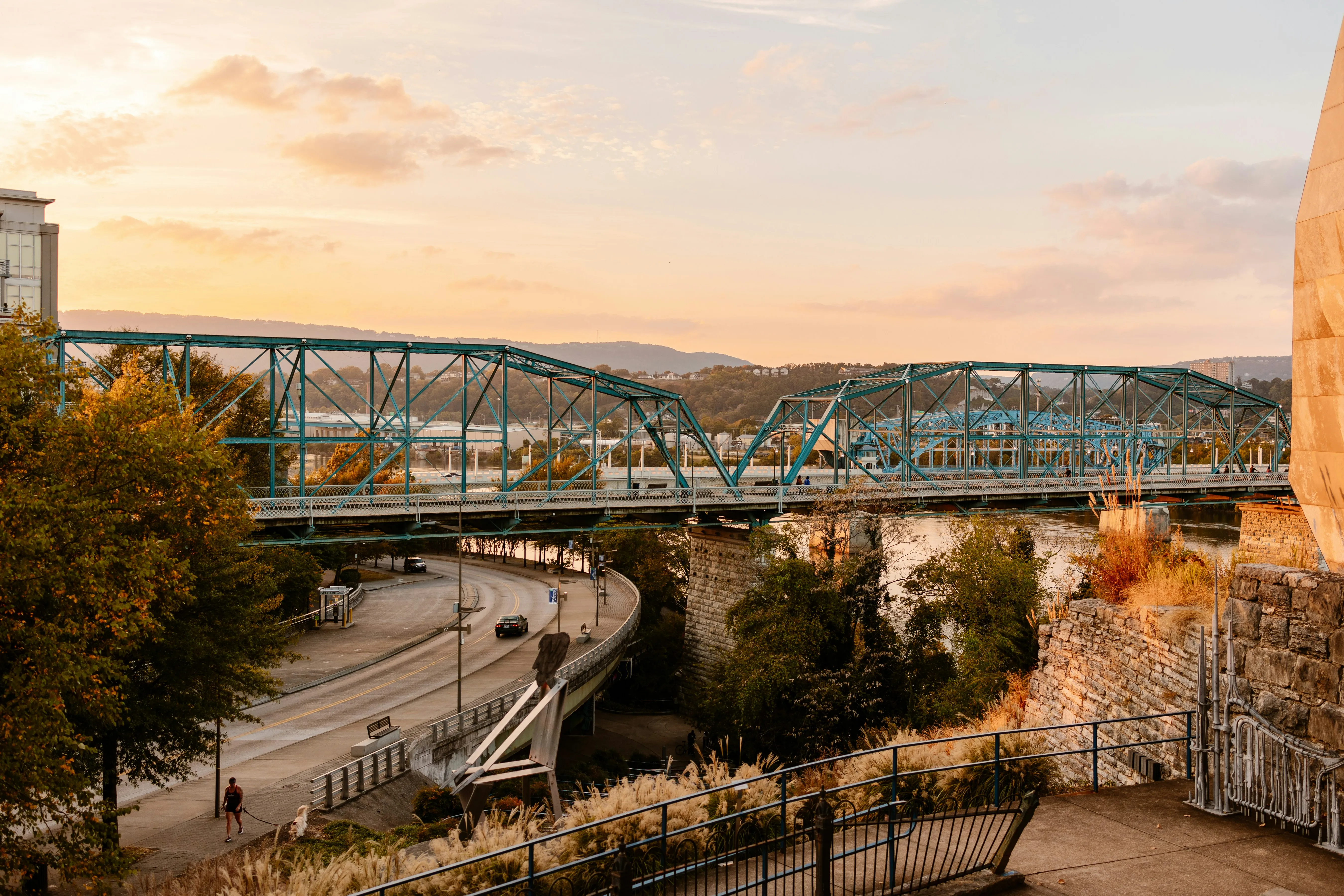 A bridge over a river next to a tall building