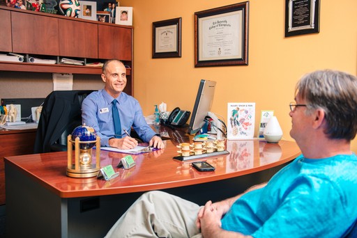 Accident Chiropractor speaking to patient after accident