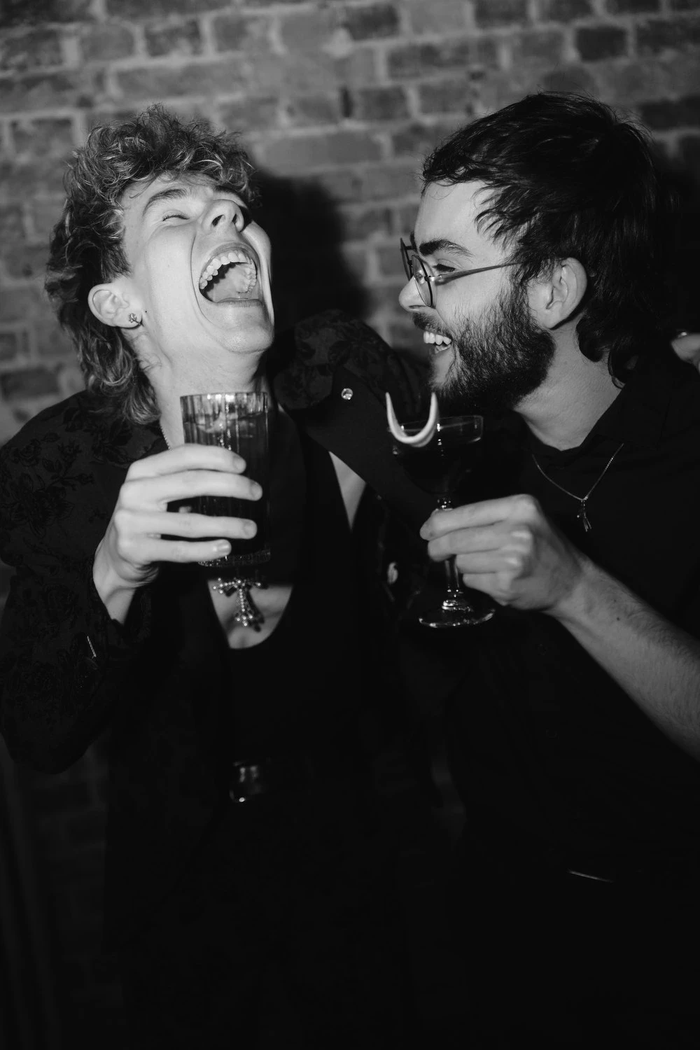 Dominik Türk and Jonathan Miehlich laughing over Drinks in a bar in stuttgart.