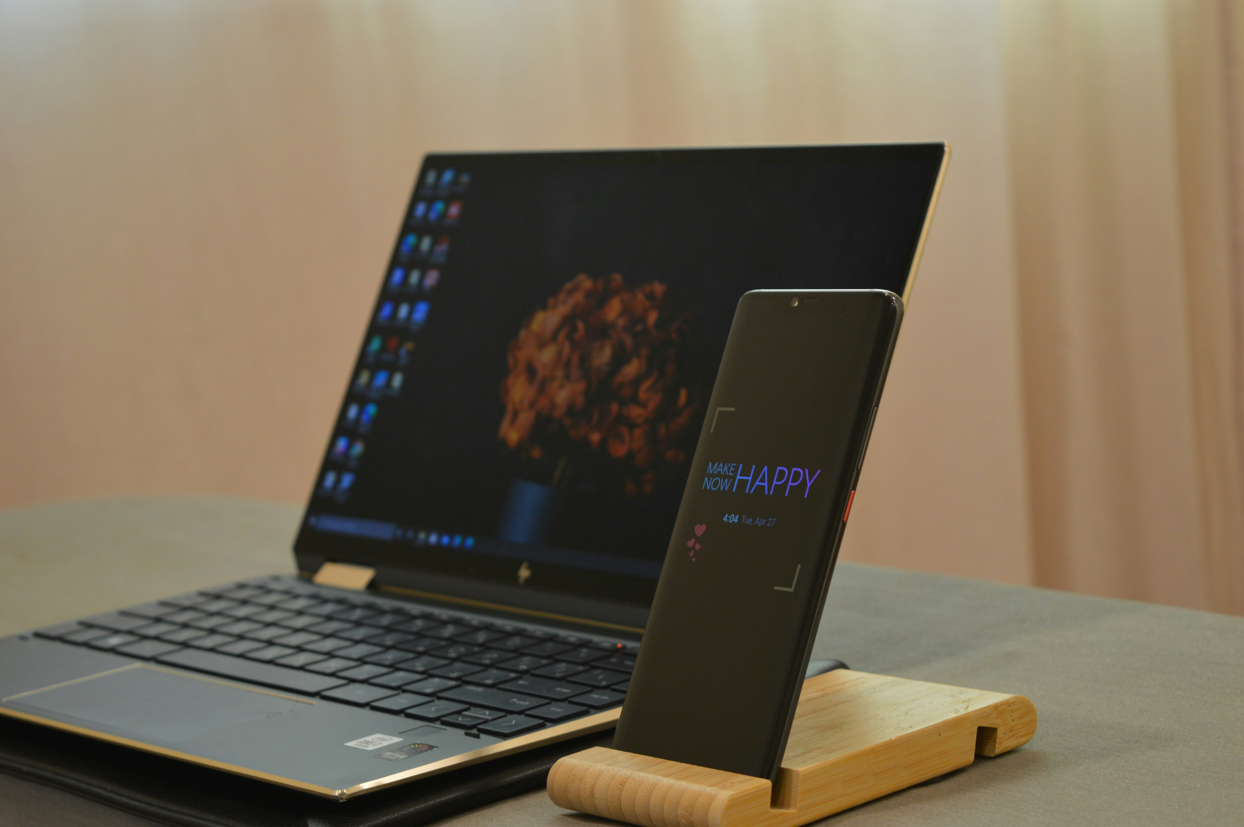 A laptop and smartphone used together for work, showing multi-device access.