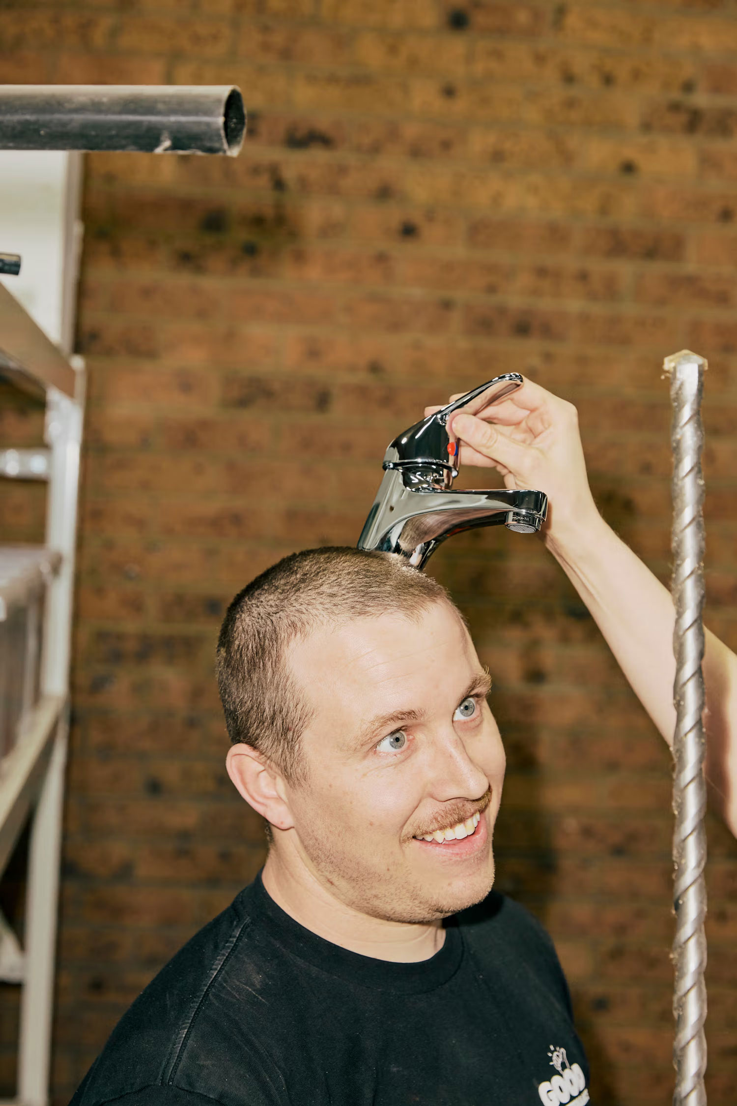 Team member with tap held playfully on his head