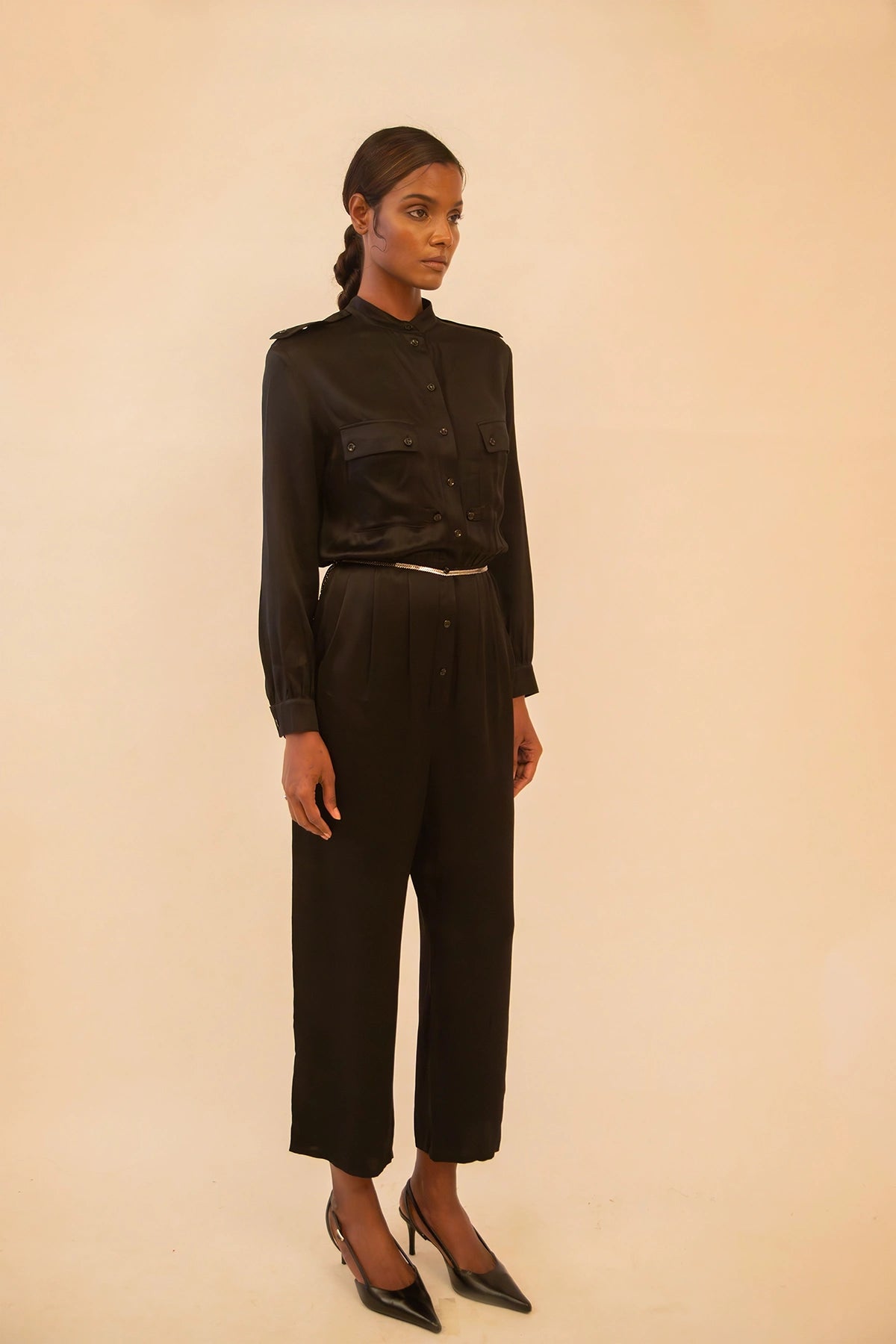 Vintage YSL black button-up jumpsuit featuring a tailored fit and classic detailing, sourced from global designer archives.
