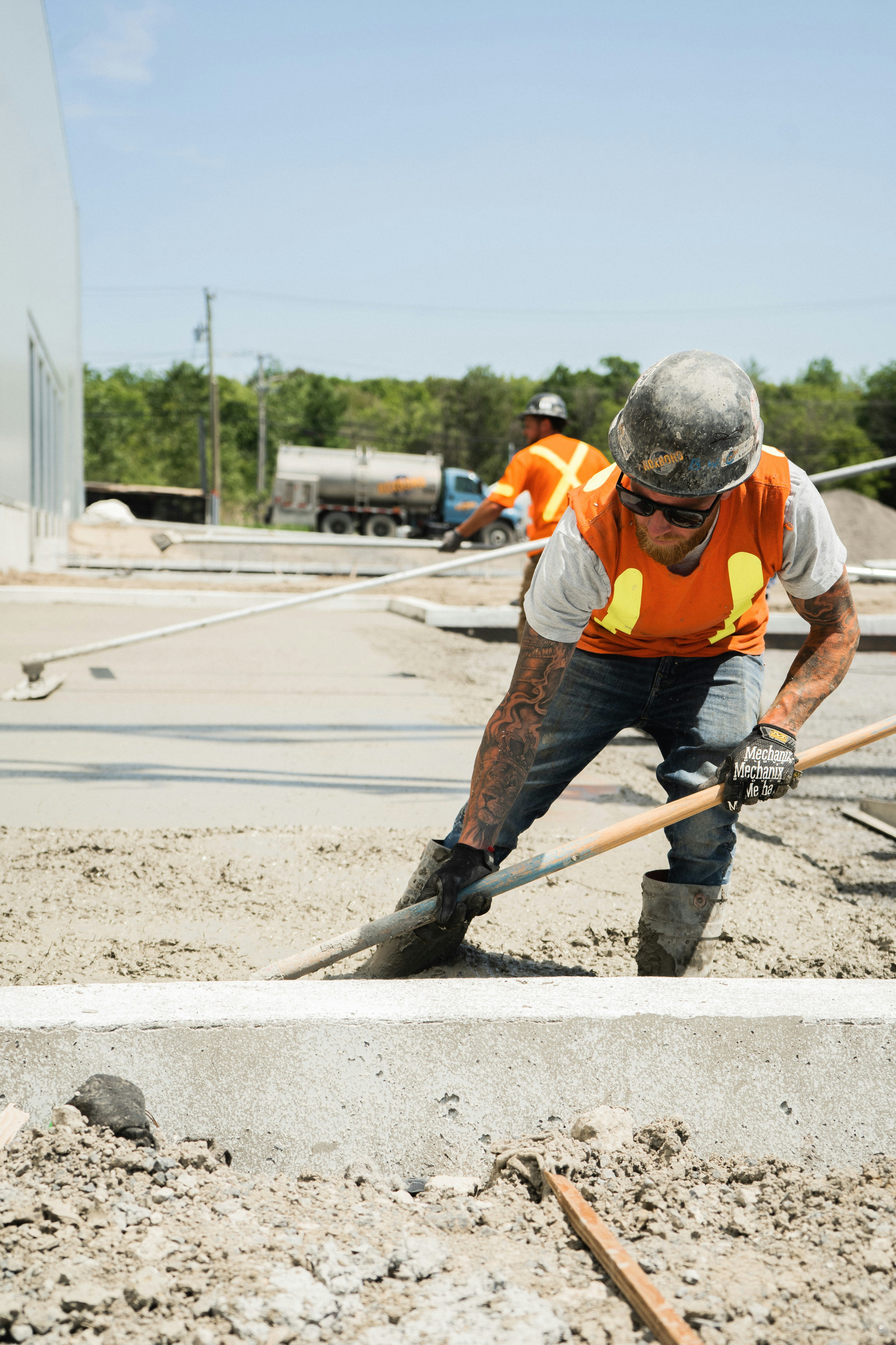 Construction worker is paving the floor.