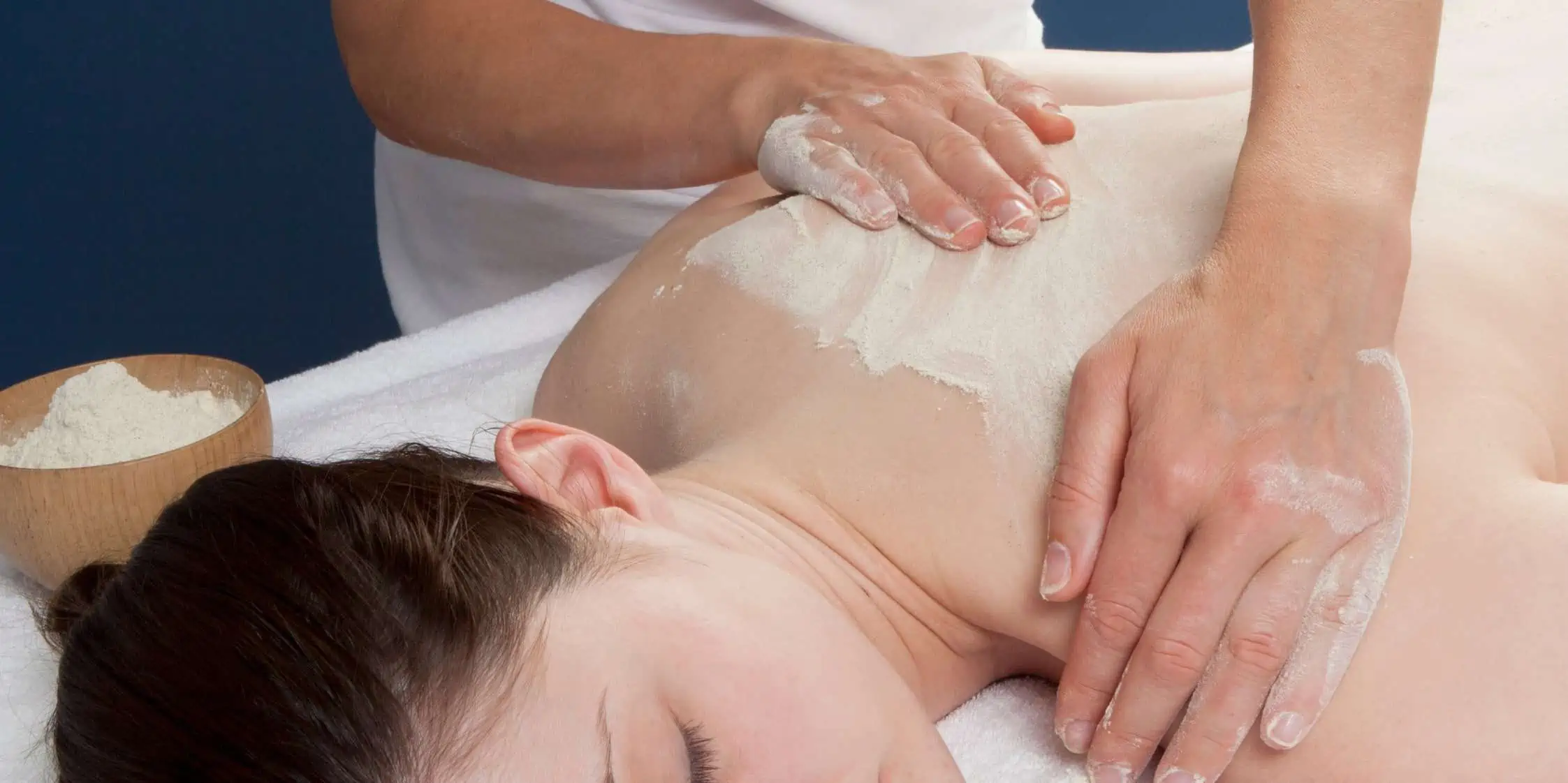 Massage is being administered to a person's back.