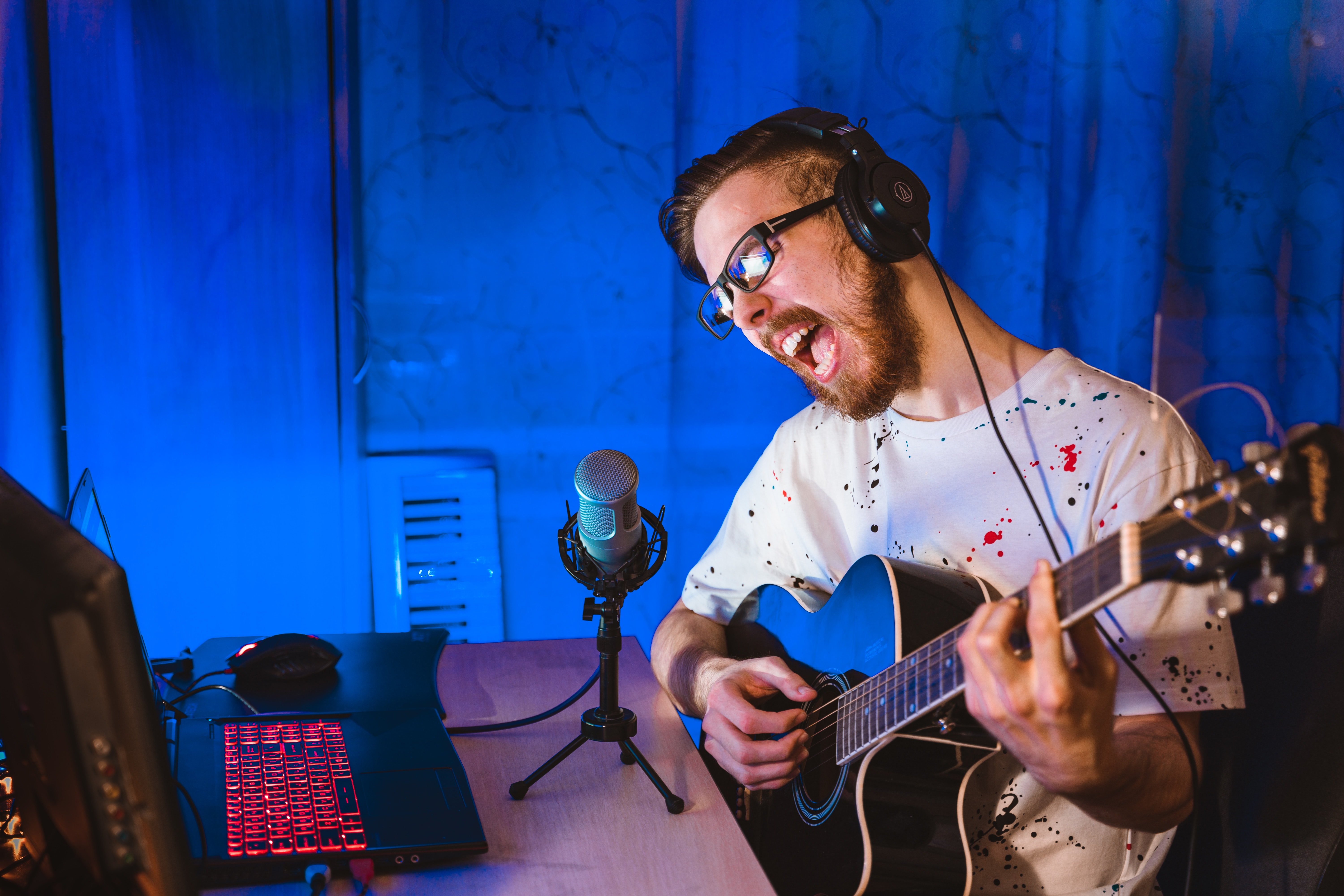 Man singing with guitar - vocalist vs singer
