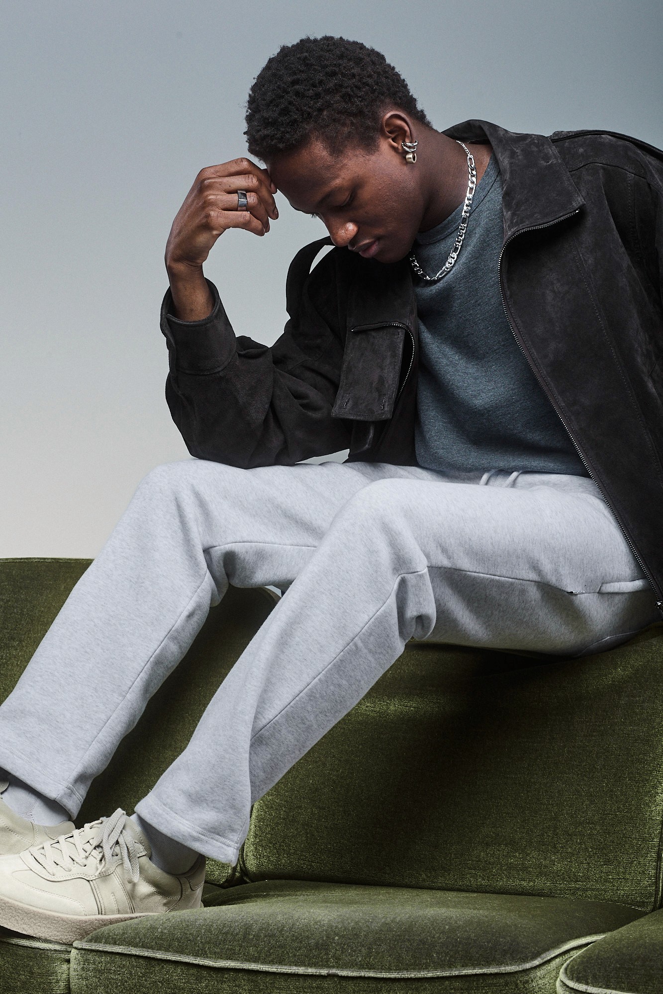 Model wearing Light grey Sunday Superior sweatpants, styled with dark outerwear