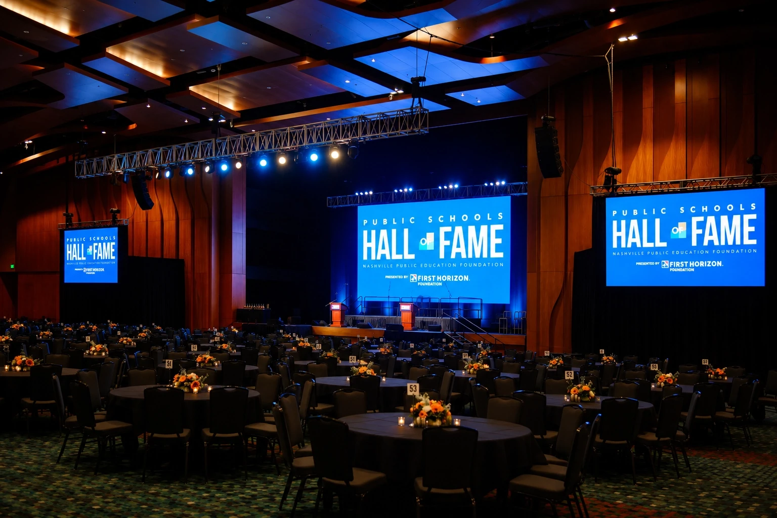 Wide ballroom with Hall of Fame video walls and blue stage lighting at the Nashville Public Education Foundation gala — corporate production by UpLight Technologies