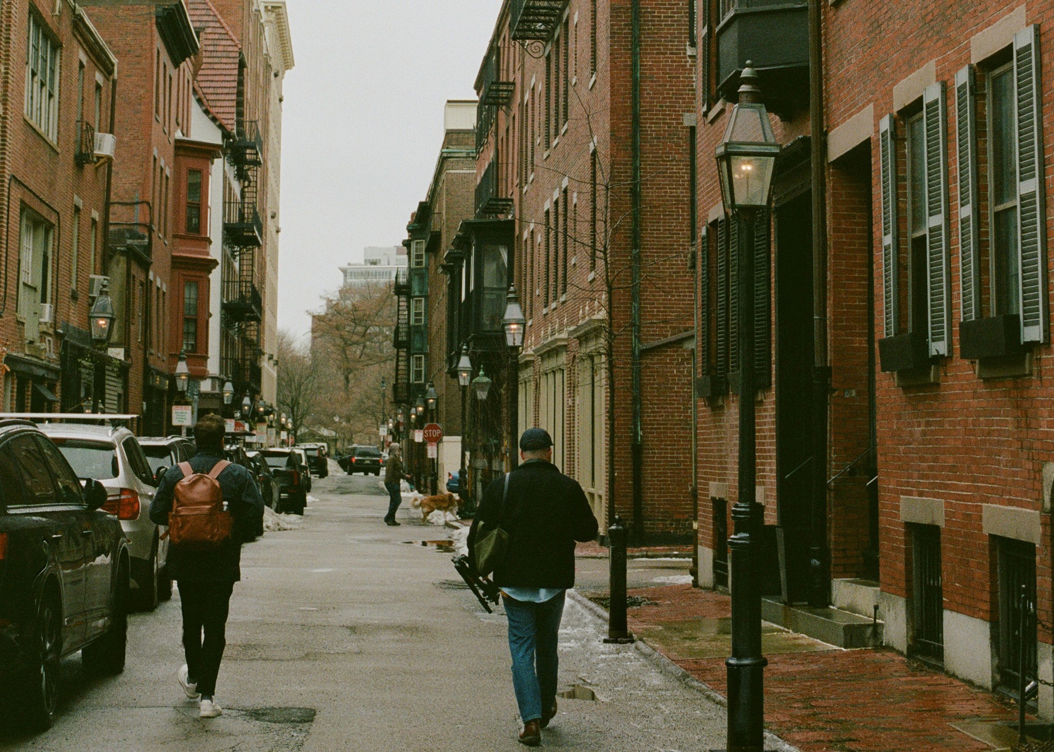 two people walking down a street