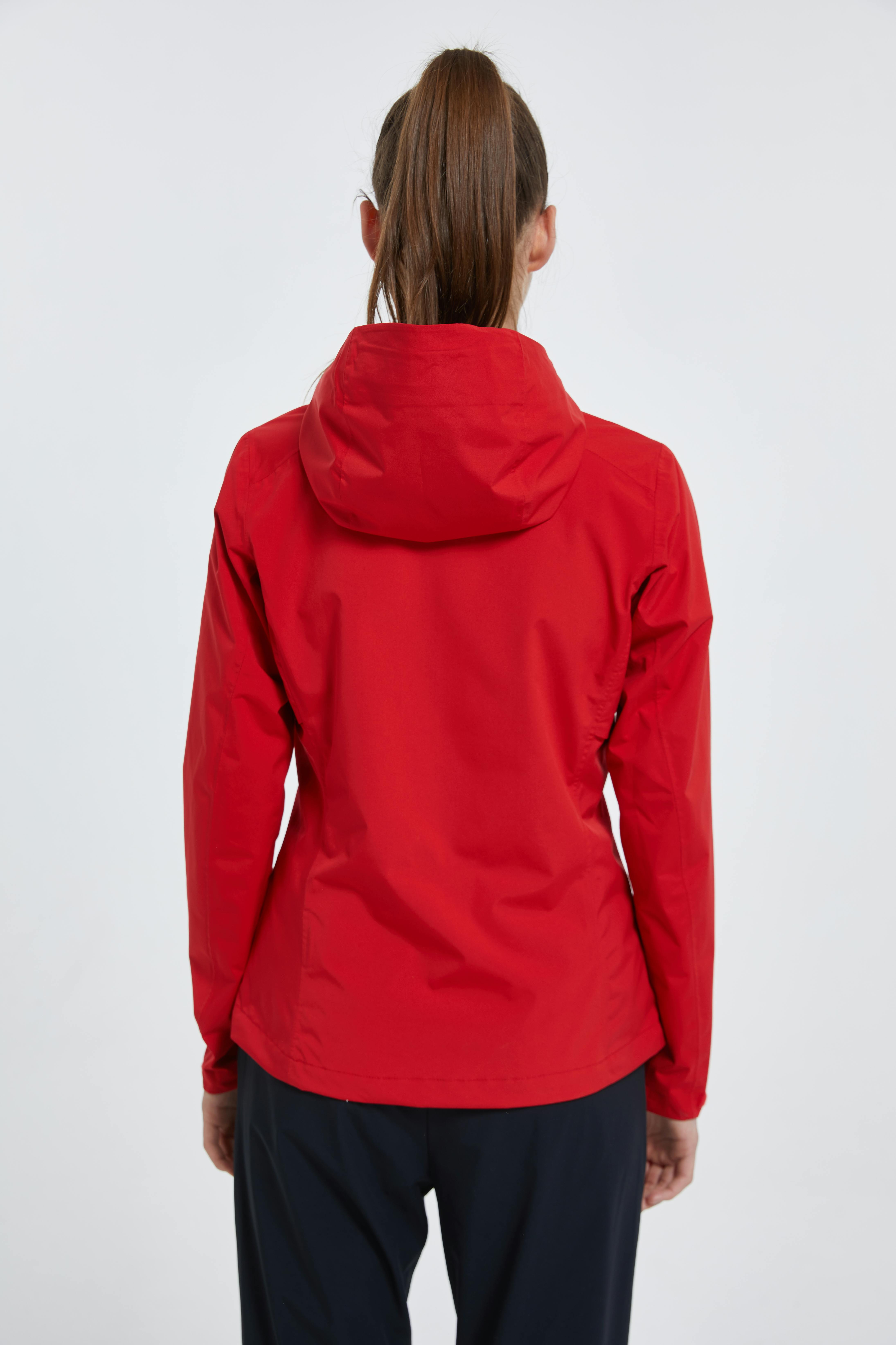 Female model is posing to show red jacket from back