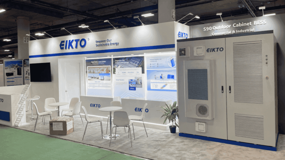 20x40 industrial energy product booth with battery equipment graphics, product demo area, lighting frame, and meeting seating