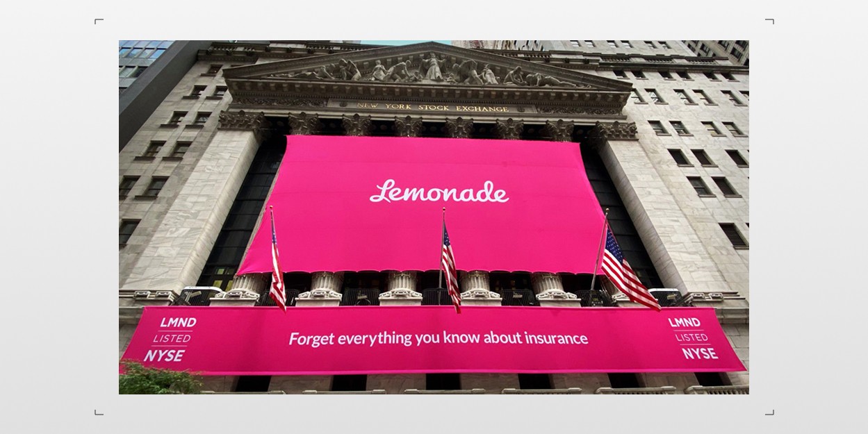 Lemonade IPO banner in bright pink covering the New York Stock Exchange facade, reading "Forget everything you know about insurance"