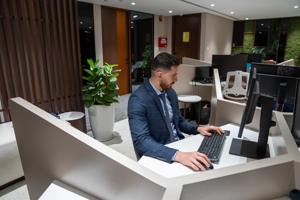 Professional at work in Office Square, Nation Towers Mall, Abu Dhabi, offering PRO services support in a dedicated, private workspace.
