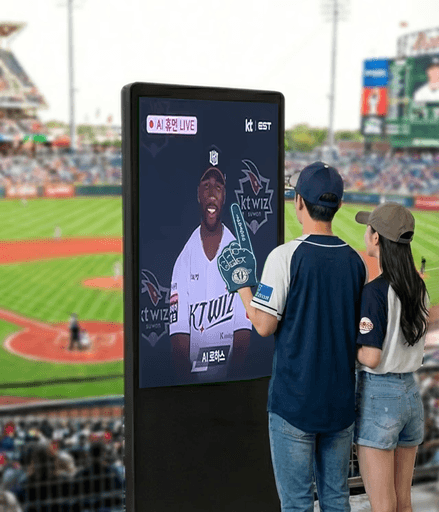 A woman in a white suit stands confidently against a bright red background, smiling with one hand on her hip.
