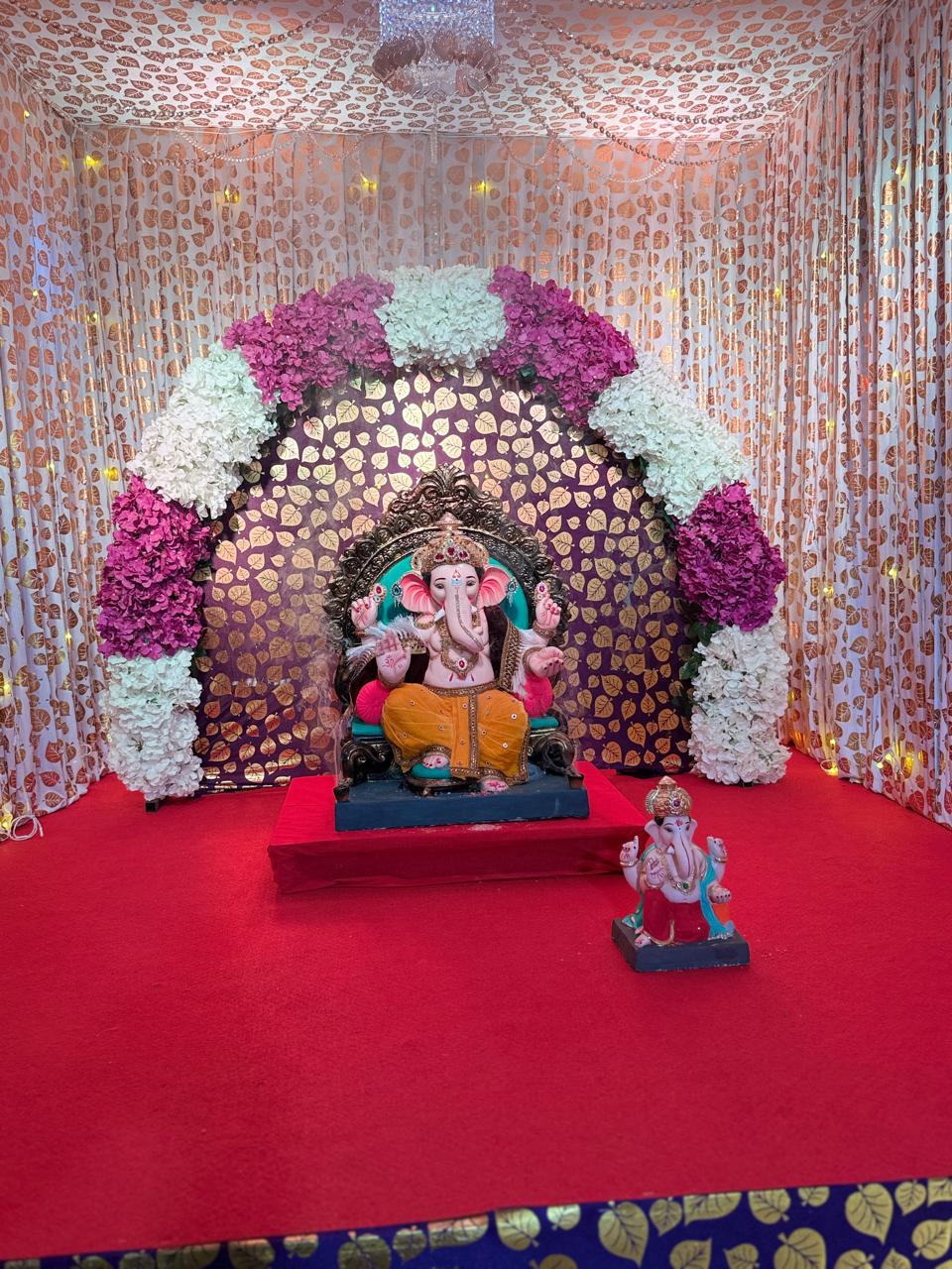 Ganpati idol adorned with marigold and roses